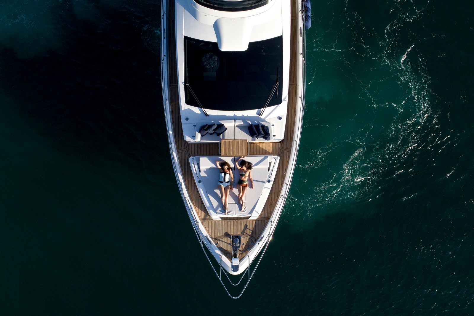 Boat photographed from directly above on dark water