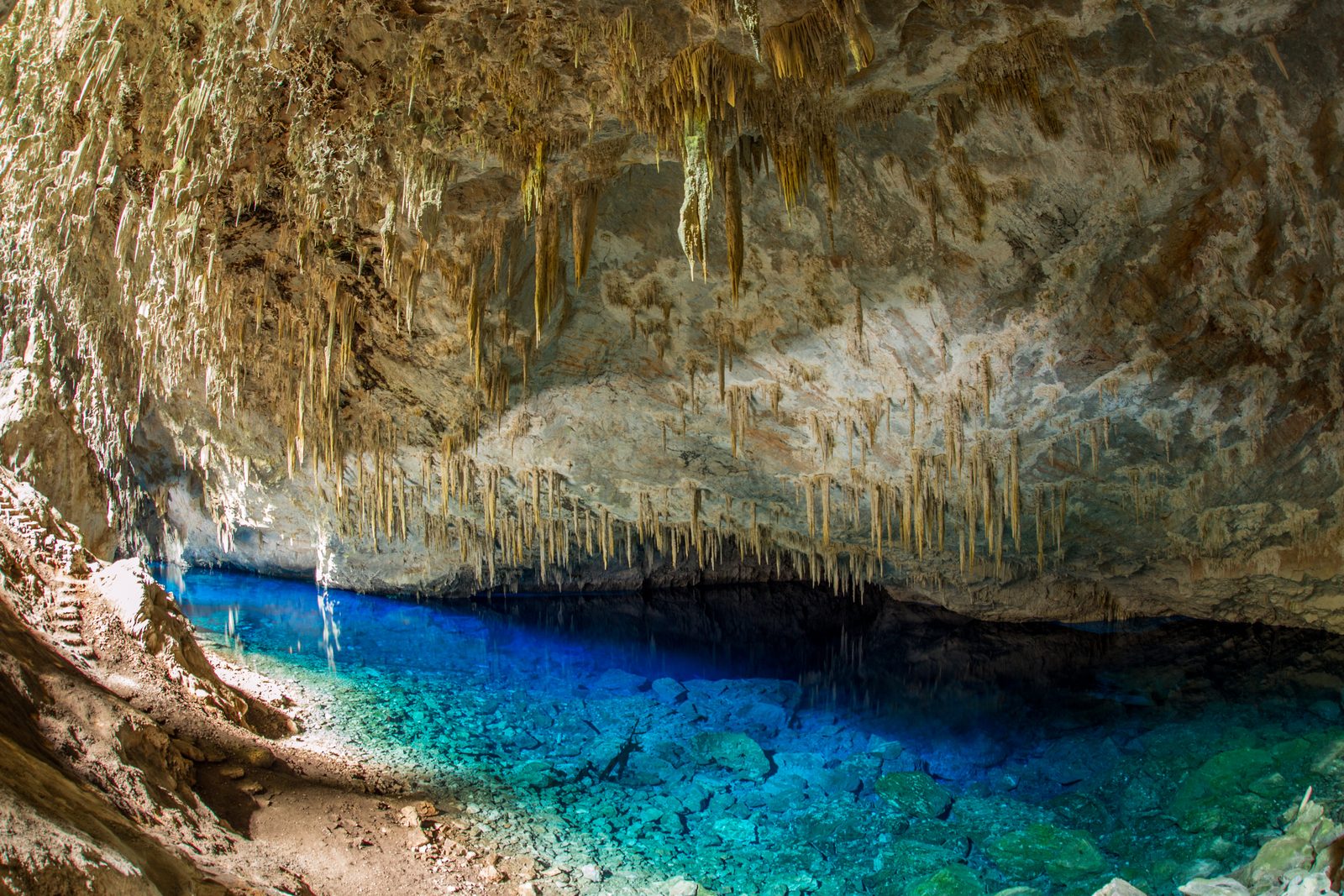 Blue pool beneath the rocky ceiling of Gruta do Lago Azul
