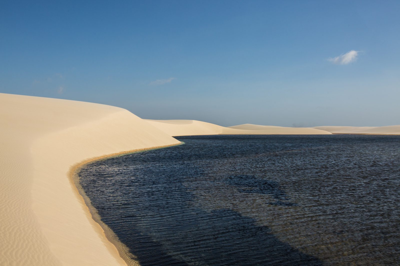Curved sand dune beside Lagoa Murici in Santo Amaro