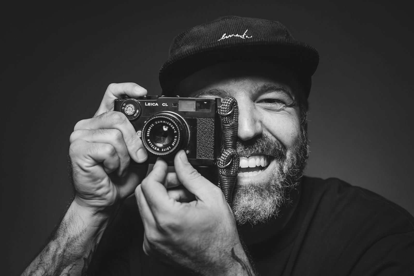 Marcel Favery smiling while holding a camera to his eye