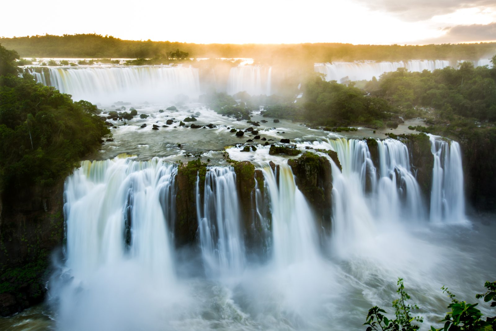 Wide waterfall cascading into a river